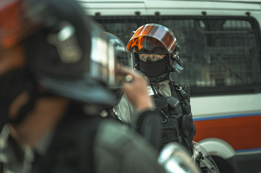 Crisis response team monitoring live broadcast feeds
